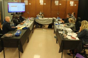 Participants from Calhoun gather around table